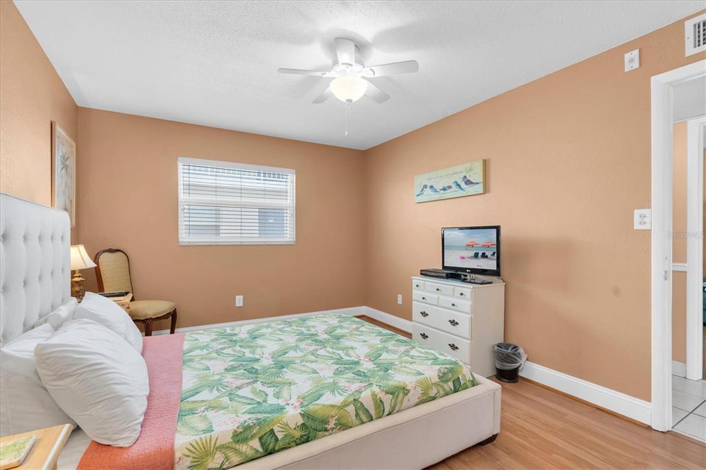 19610 Gulf Boulevard, Unit 308 Indian Rocks Beach, FL 33785 - Photo 18 of 41 a bedroom with a bed and a chandelier