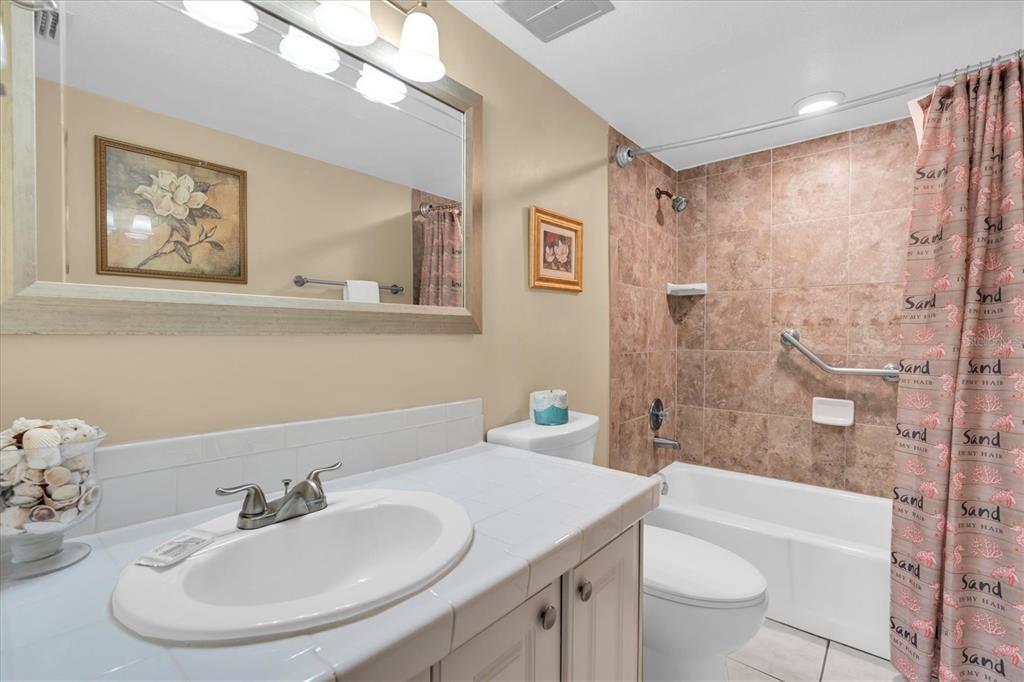 19610 Gulf Boulevard, Unit 308 Indian Rocks Beach, FL 33785 - Photo 19 of 41 a bathroom with a sink toilet and shower