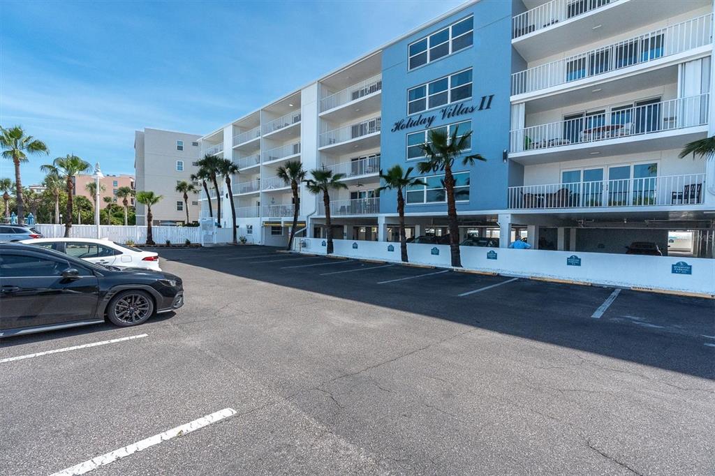 19610 Gulf Boulevard, Unit 308 Indian Rocks Beach, FL 33785 - Photo 2 of 41 a view of building with cars parked in front of it