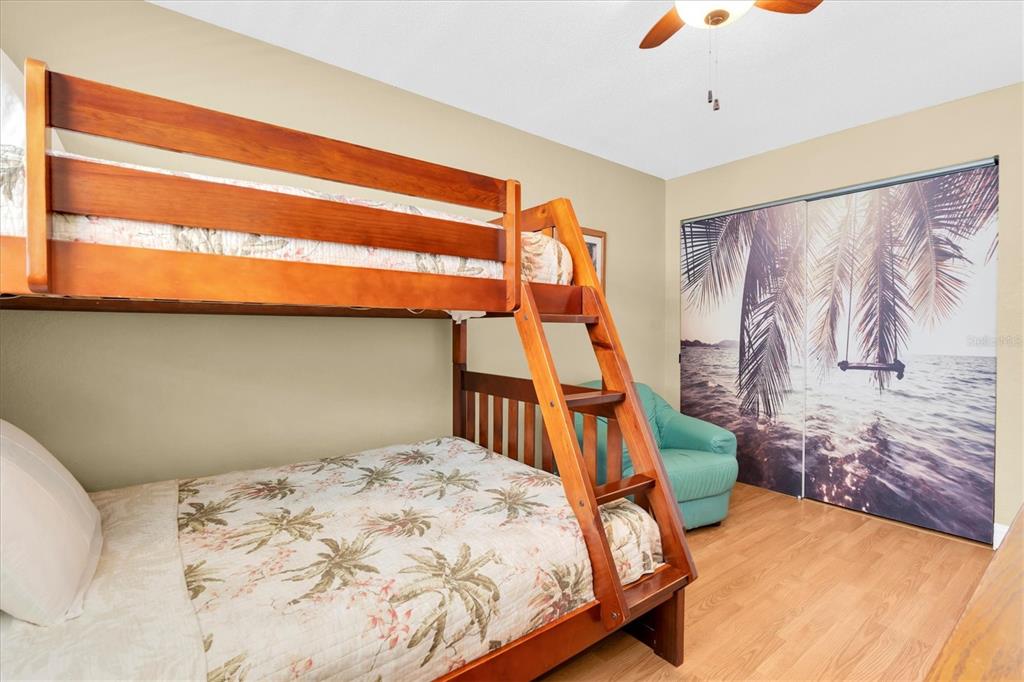 19610 Gulf Boulevard, Unit 308 Indian Rocks Beach, FL 33785 - Photo 21 of 41 a bedroom with a bed and a painting on the wall