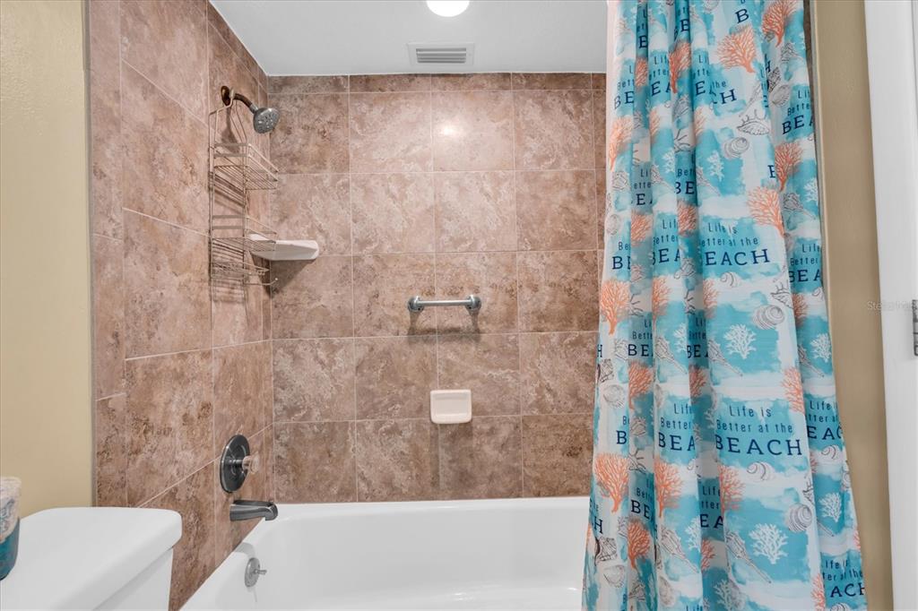 19610 Gulf Boulevard, Unit 308 Indian Rocks Beach, FL 33785 - Photo 23 of 41 a bathroom with a shower and a toilet