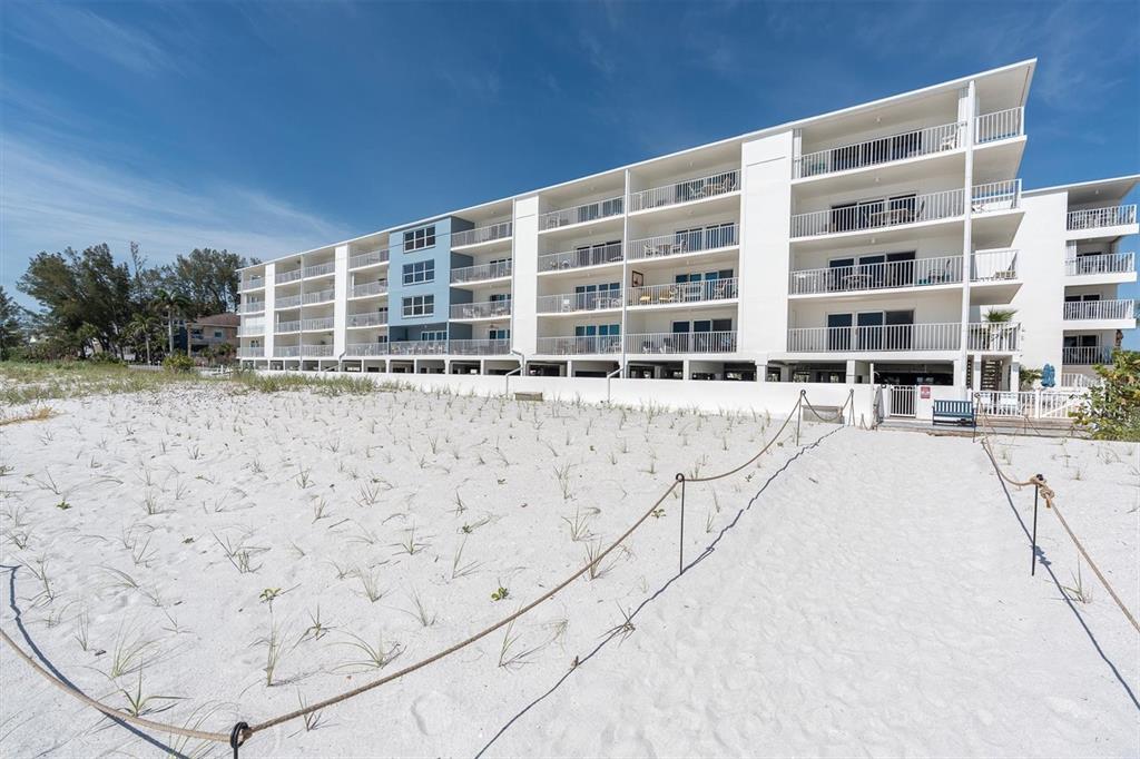 19610 Gulf Boulevard, Unit 308 Indian Rocks Beach, FL 33785 - Photo 39 of 41 a view of building with parking space