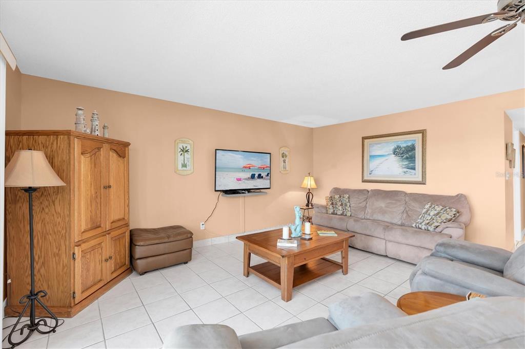 19610 Gulf Boulevard, Unit 308 Indian Rocks Beach, FL 33785 - Photo 7 of 41 a living room with furniture and a table
