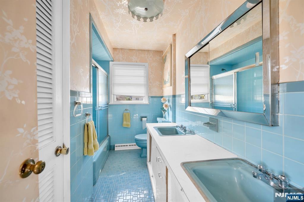 204 Tryon Place Paramus, NJ 07652 - Photo 15 of 33 a bathroom with a sink a toilet and mirror