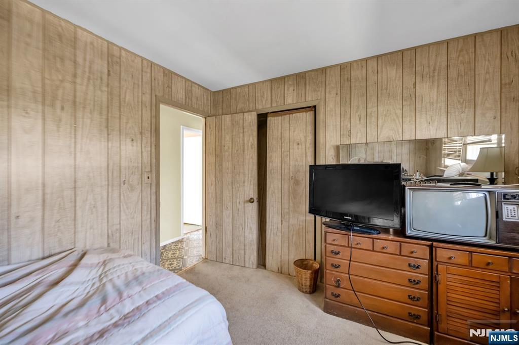 204 Tryon Place Paramus, NJ 07652 - Photo 19 of 33 a bedroom with a bed and a flat screen tv