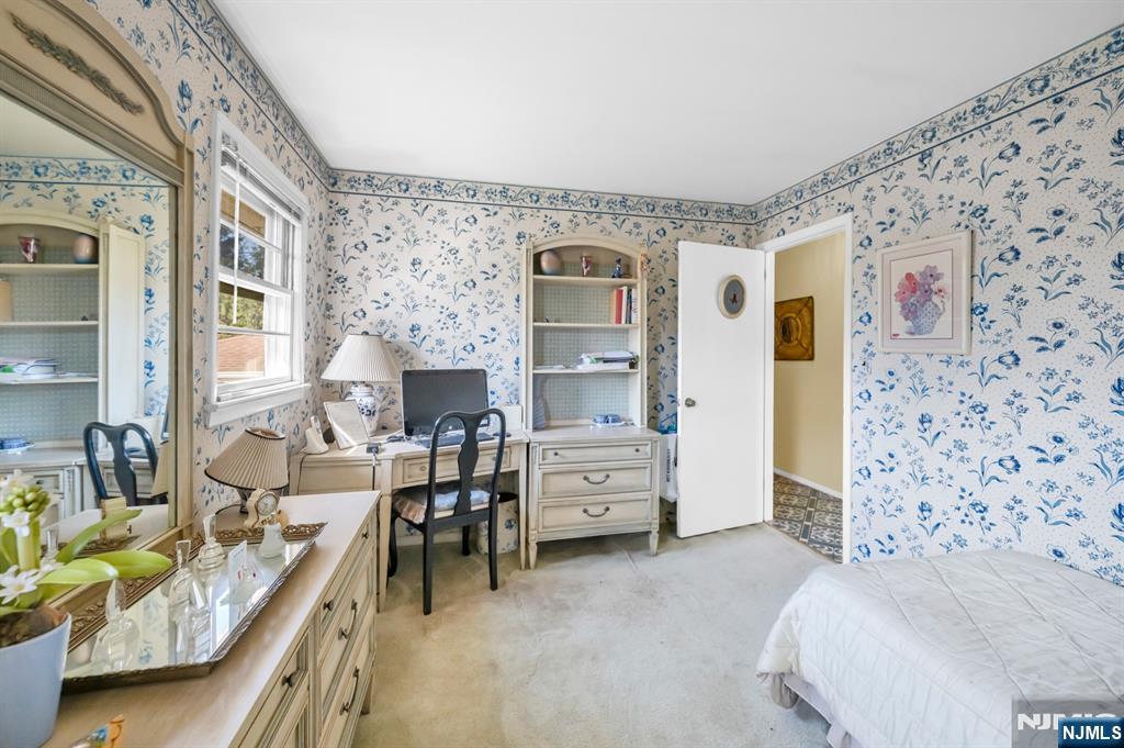 204 Tryon Place Paramus, NJ 07652 - Photo 21 of 33 a bedroom with furniture and a chandelier