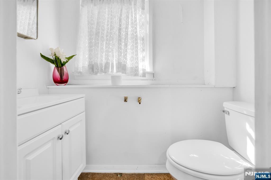 204 Tryon Place Paramus, NJ 07652 - Photo 28 of 33 a white toilet sitting next to a window