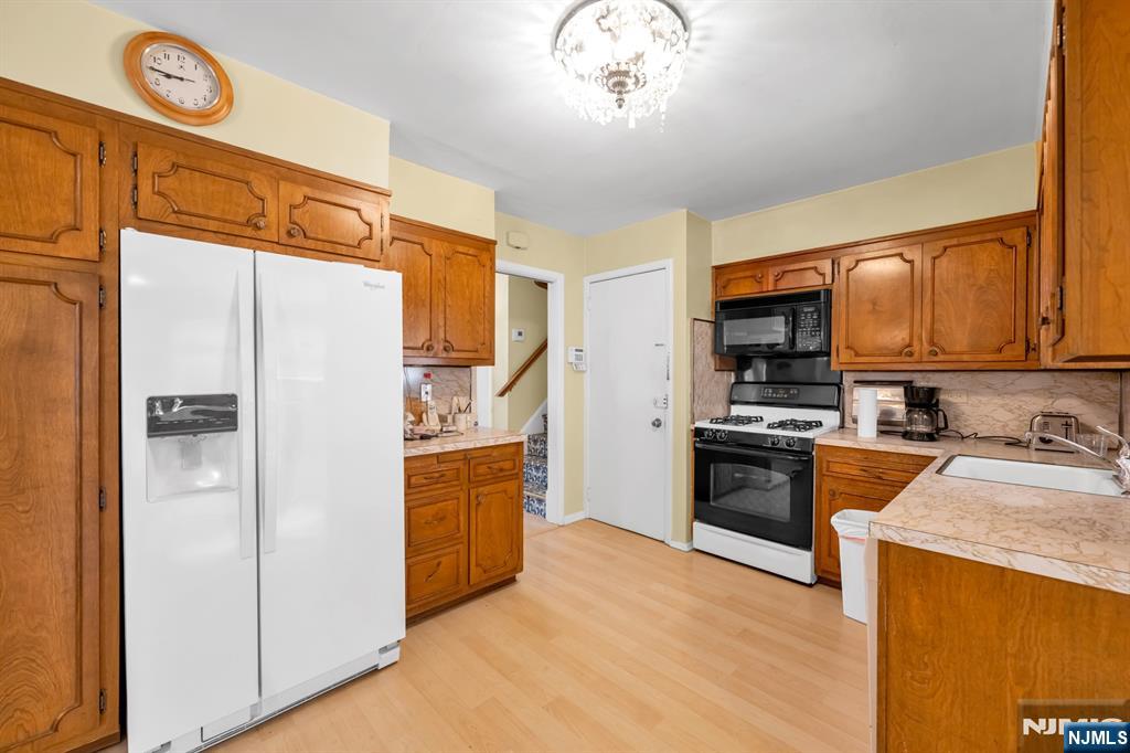 204 Tryon Place Paramus, NJ 07652 - Photo 6 of 33 a kitchen with stainless steel appliances granite countertop a refrigerator stove and oven