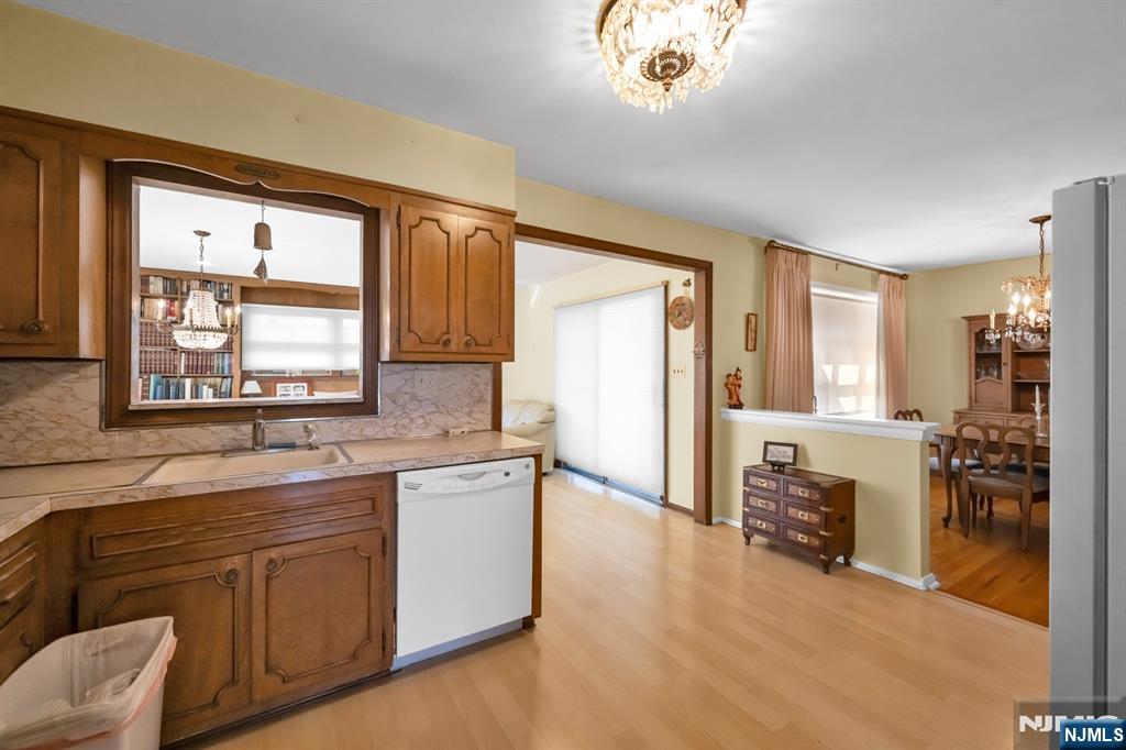 204 Tryon Place Paramus, NJ 07652 - Photo 7 of 33 a kitchen with stainless steel appliances granite countertop a stove a sink and a refrigerator with wooden floor