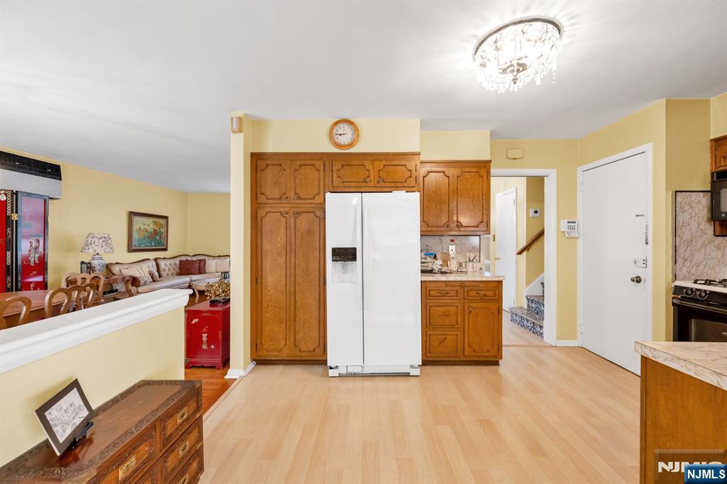 204 Tryon Place Paramus, NJ 07652 - Photo 9 of 33 a view of a livingroom with wooden floor and kitchen space