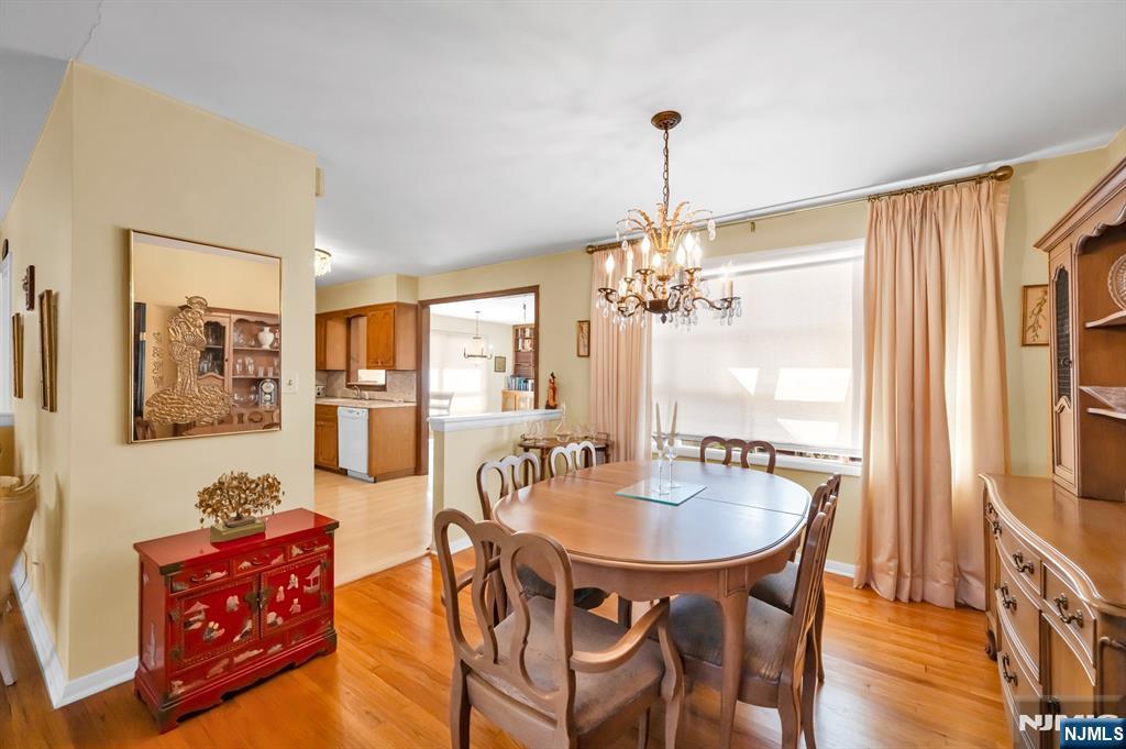 204 Tryon Place Paramus, NJ 07652 - Photo 10 of 33 a dining room with furniture a chandelier and wooden floor