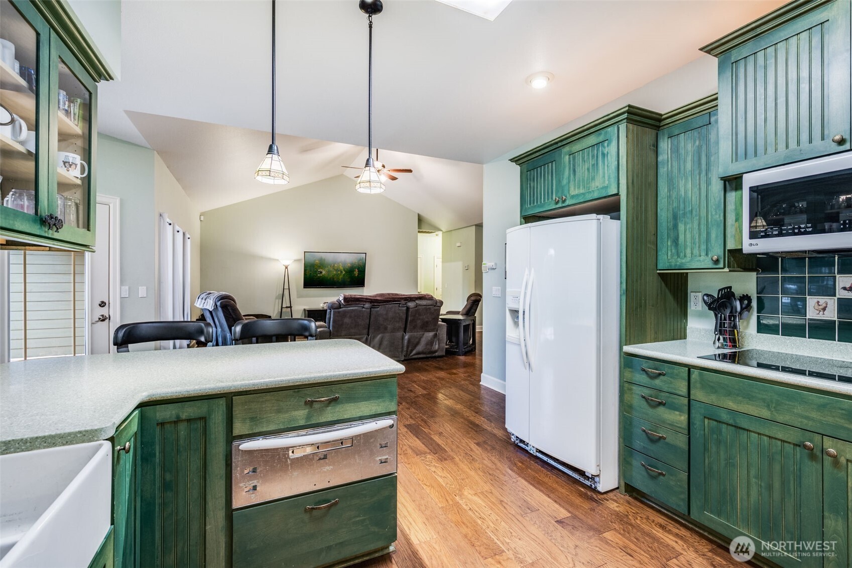 36612 2nd Avenue South Roy, WA 98580 - Photo 17 of 40 a kitchen with kitchen island a stove a refrigerator and a sink