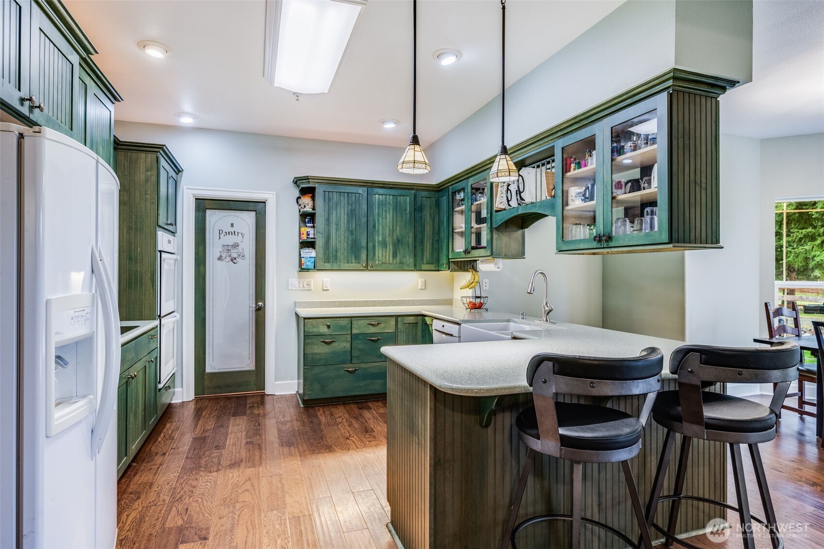36612 2nd Avenue South Roy, WA 98580 - Photo 9 of 40 a kitchen with a table chairs refrigerator and microwave