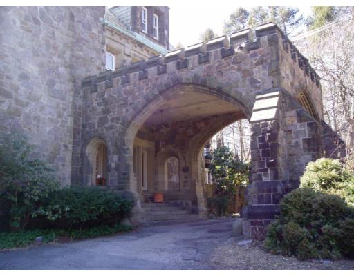 62 Buckminster Road Brookline, MA 02445 - Photo 3 of 9 a view of a stone house with a small yard plants and large tree