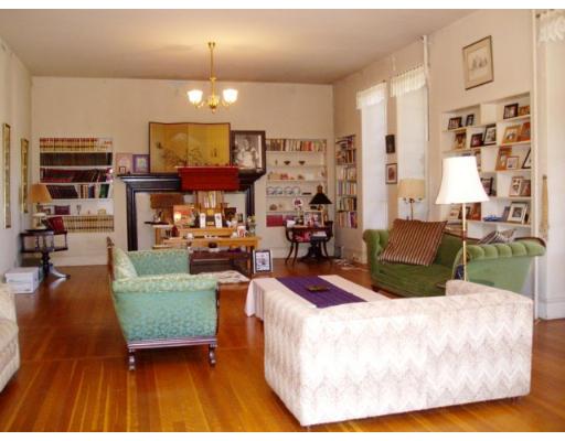 62 Buckminster Road Brookline, MA 02445 - Photo 8 of 9 a living room with furniture a fireplace and a chandelier