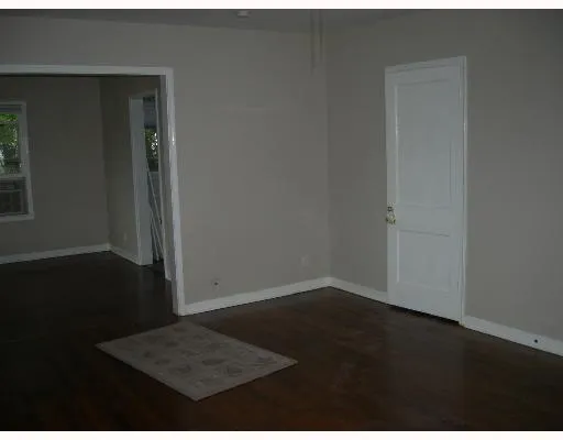 an empty room with wooden floor