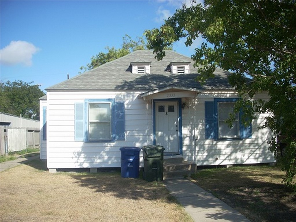 2333 Riggan Street Corpus Christi, TX 78404 - Photo 1 of 12 a front view of a house with a garden
