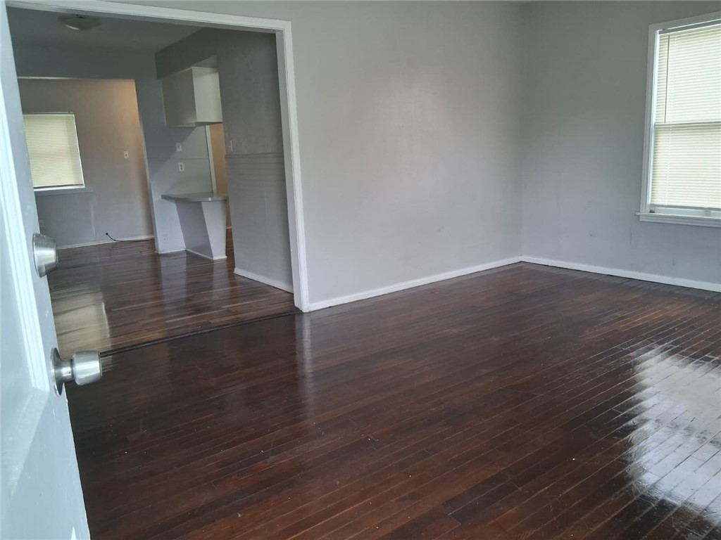2333 Riggan Street Corpus Christi, TX 78404 - Photo 2 of 12 wooden floor in an empty room with a window