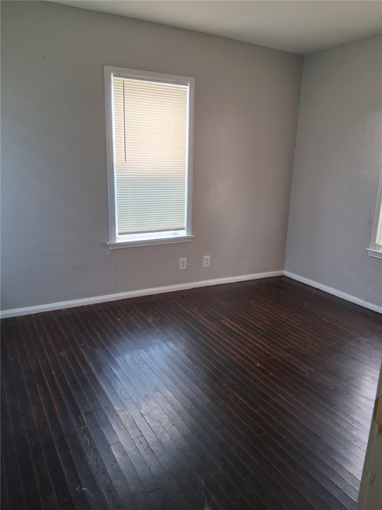 2333 Riggan Street Corpus Christi, TX 78404 - Photo 5 of 12 a view of an empty room with wooden floor and a window