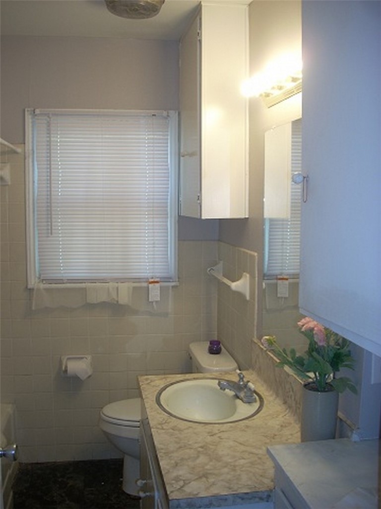 2333 Riggan Street Corpus Christi, TX 78404 - Photo 7 of 12 a bathroom with a sink a toilet and a mirror