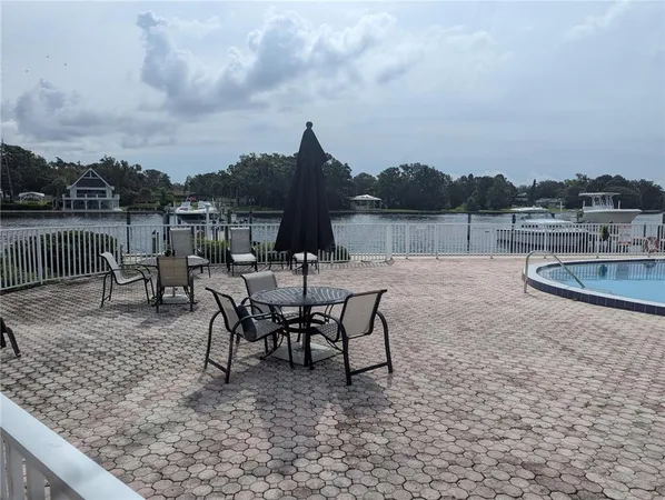 a view of a lake with table and chairs