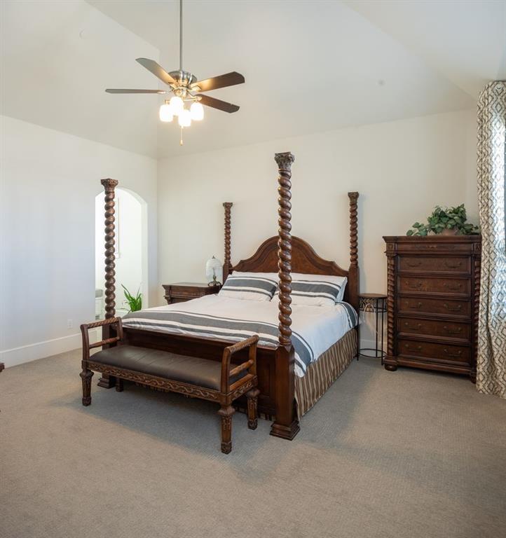 1755 Heifner Road Lucas, TX 75002 - Photo 19 of 35 a bedroom with a bed and a chandelier