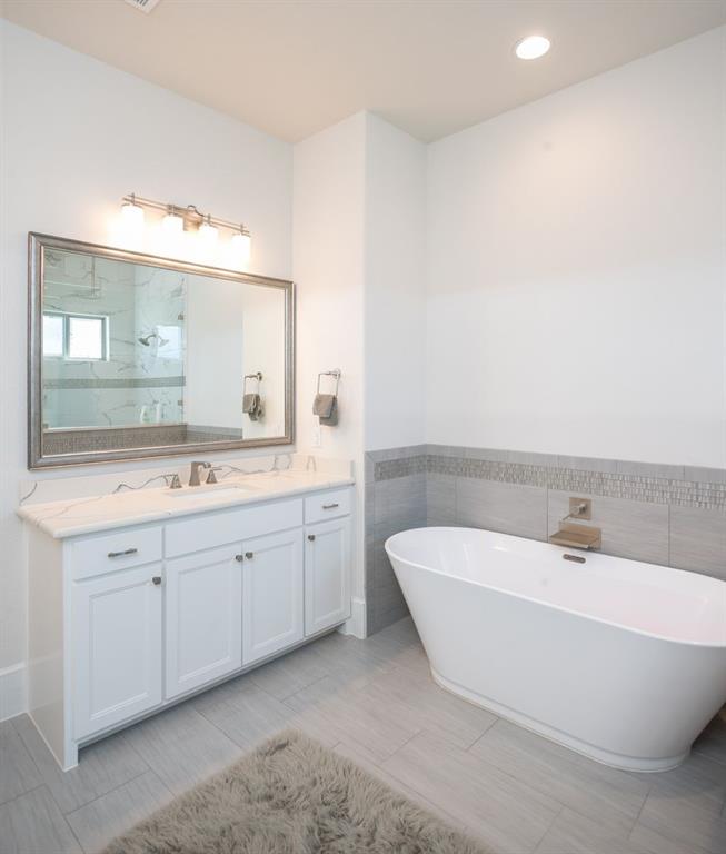 1755 Heifner Road Lucas, TX 75002 - Photo 22 of 35 a spacious bathroom with a double vanity sink mirror and a bathtub