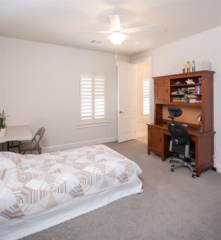 1755 Heifner Road Lucas, TX 75002 - Photo 24 of 35 a bedroom with a bed and a desk