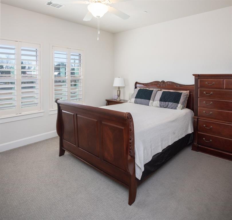 1755 Heifner Road Lucas, TX 75002 - Photo 27 of 35 a bedroom with a bed and a dresser next to a window