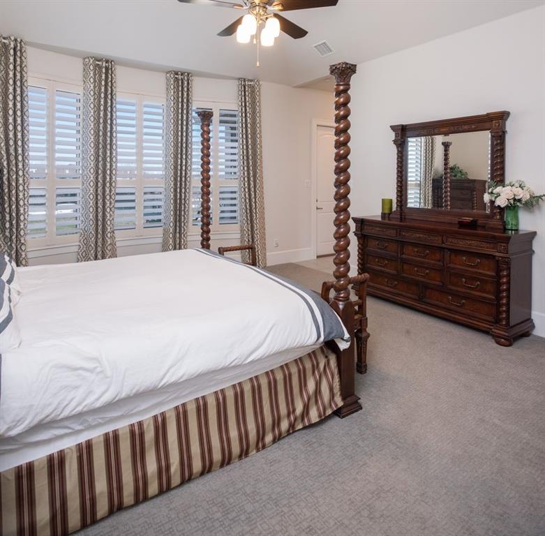 1755 Heifner Road Lucas, TX 75002 - Photo 28 of 35 a bedroom with a bed and a dresser in it