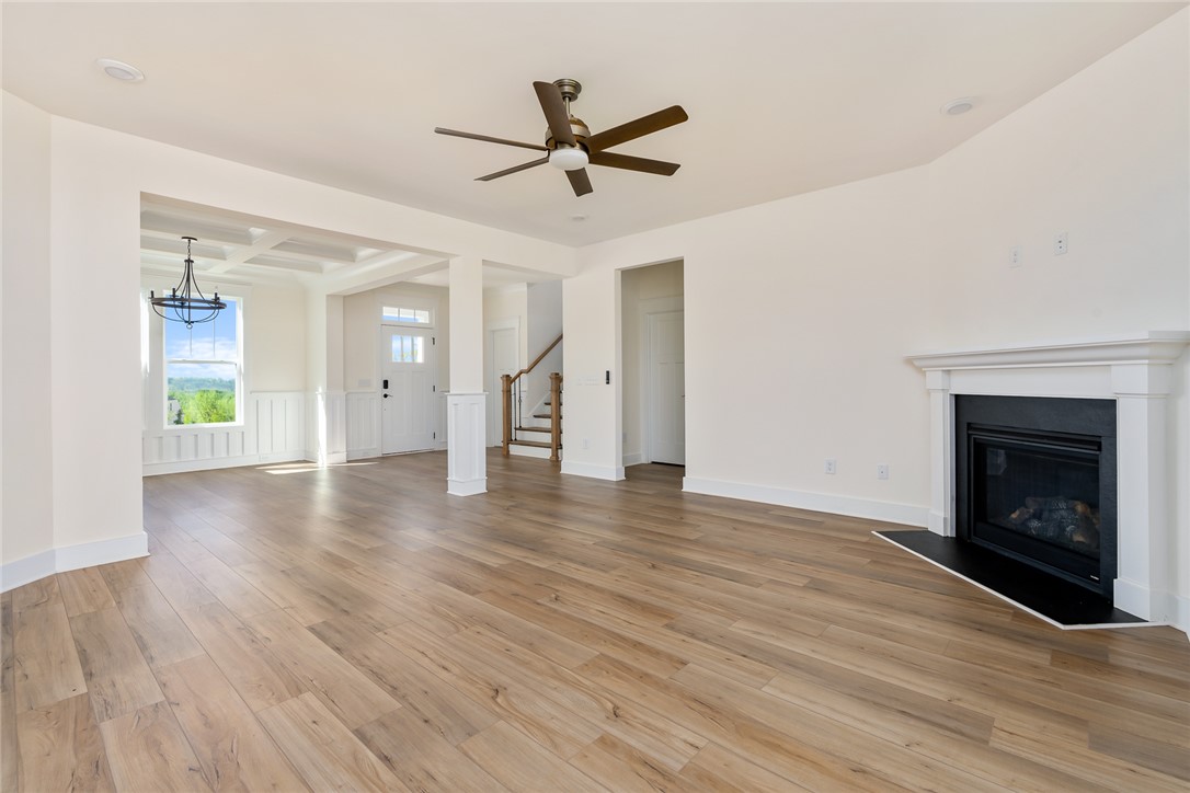 134 Ridgeline Row Central, SC 29630 - Photo 11 of 47 This expansive living area offers seamless flow, warm flooring, and a welcoming fireplace.