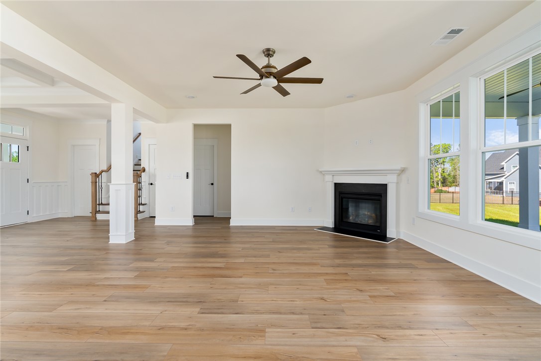 134 Ridgeline Row Central, SC 29630 - Photo 12 of 47 This versatile living space features warm flooring, a cozy fireplace, and ample natural light.