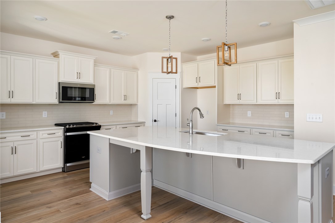 134 Ridgeline Row Central, SC 29630 - Photo 14 of 47 This kitchen features a bright and spacious design, complete with an island and ample cabinet space.