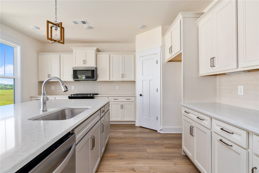 134 Ridgeline Row Central, SC 29630 - Photo 15 of 47 This modern kitchen features crisp white cabinetry and bright countertops.