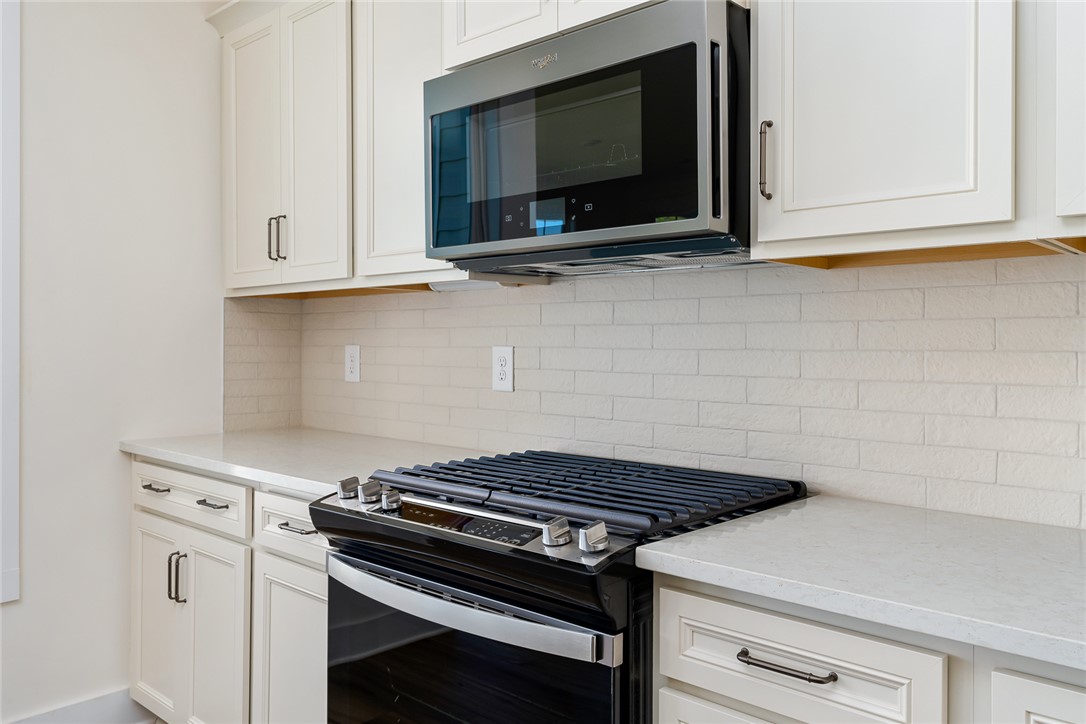 134 Ridgeline Row Central, SC 29630 - Photo 17 of 47 This modern kitchen features crisp cabinetry, sleek appliances, and elegant countertops.
