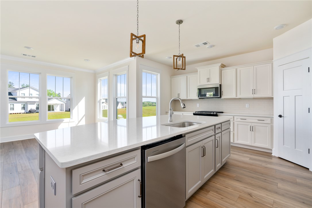 134 Ridgeline Row Central, SC 29630 - Photo 18 of 47 Bright and airy, this kitchen features a central island, ample cabinetry, and modern appliances.