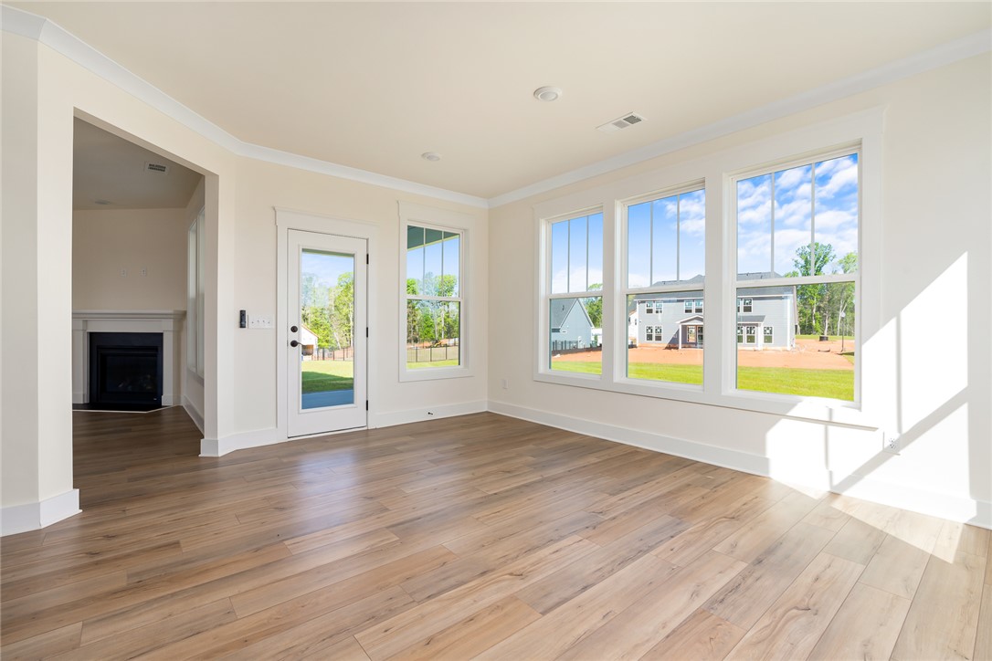 134 Ridgeline Row Central, SC 29630 - Photo 19 of 47 This bright living space features wood flooring and a fireplace, offering comfort and warmth.