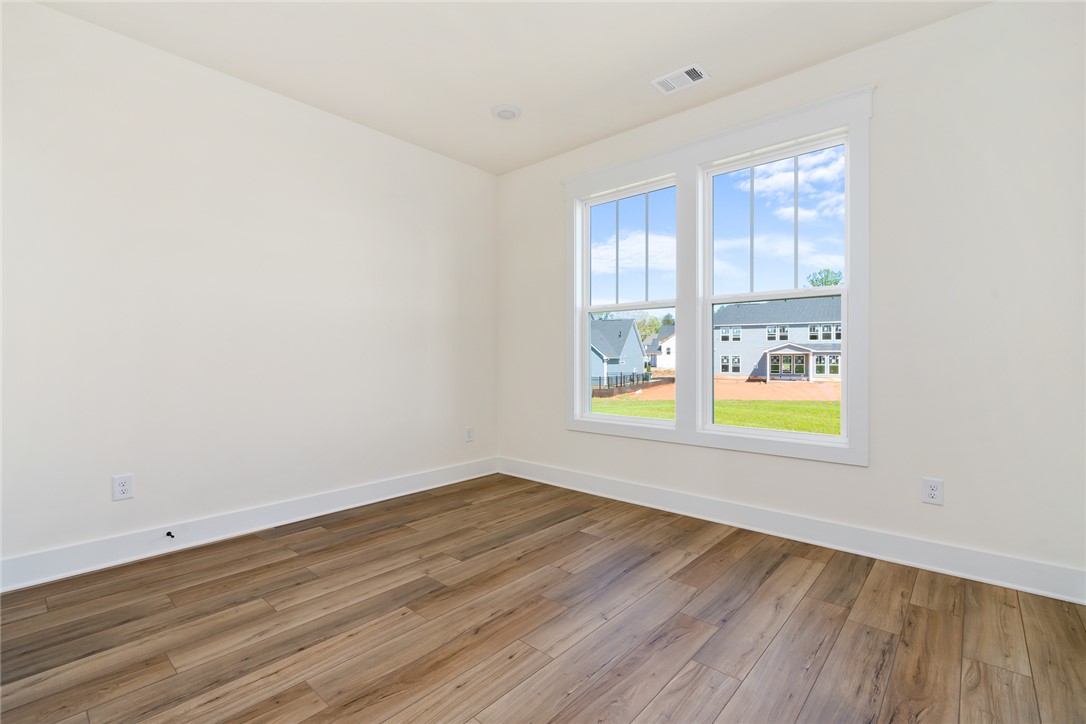 134 Ridgeline Row Central, SC 29630 - Photo 23 of 47 This bright room features durable flooring and ample natural light, creating a versatile living space.