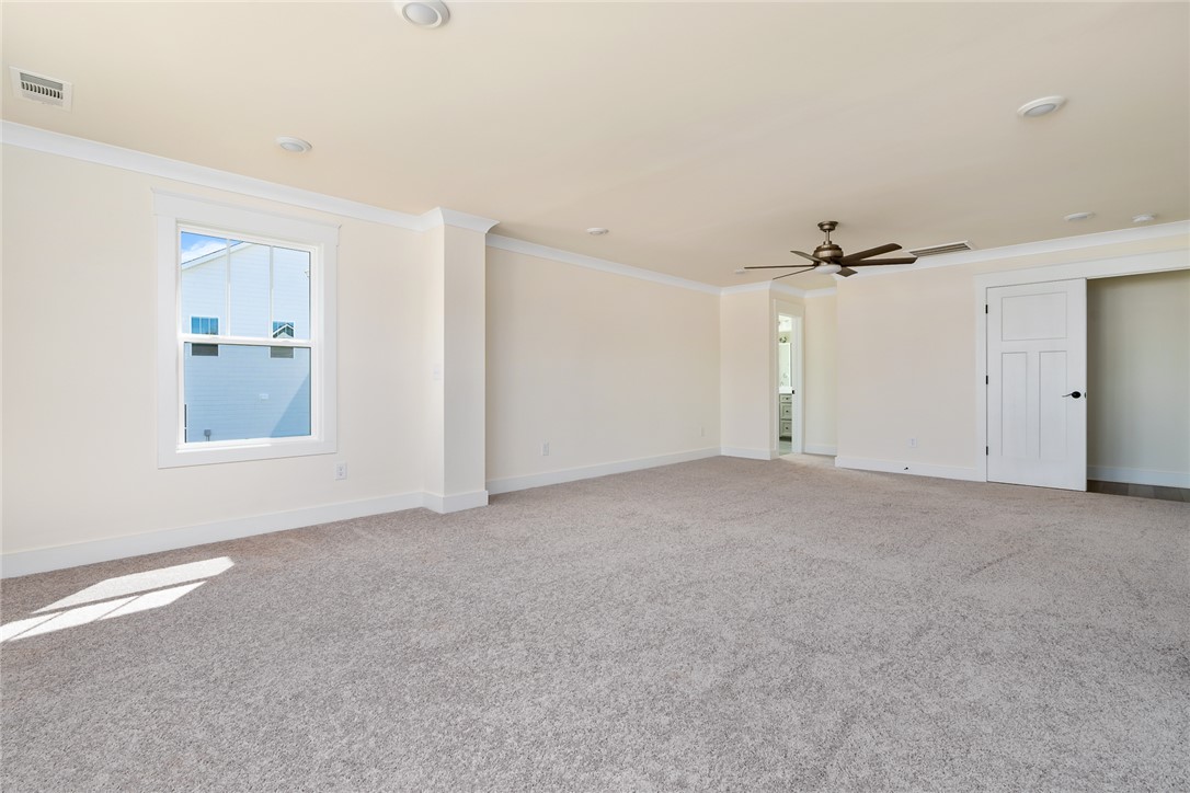 134 Ridgeline Row Central, SC 29630 - Photo 28 of 47 This expansive primary bedroom offers ample space and plush carpeting, with a convenient ensuite bathroom.