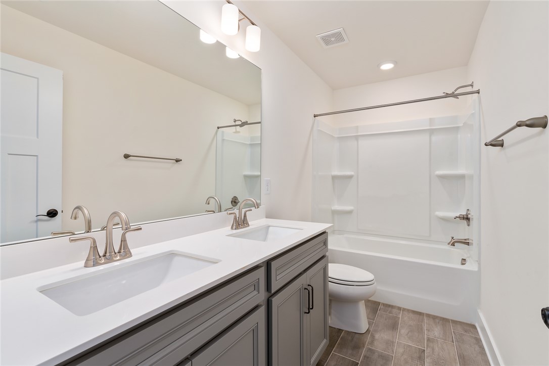 134 Ridgeline Row Central, SC 29630 - Photo 35 of 47 This modern bathroom features a dual vanity and a tub-shower combination, providing both style and function.