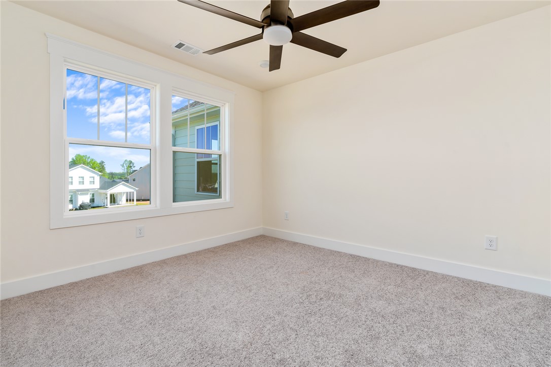 134 Ridgeline Row Central, SC 29630 - Photo 37 of 47 Bright and airy, this room features carpeted floors and large windows inviting abundant natural light.