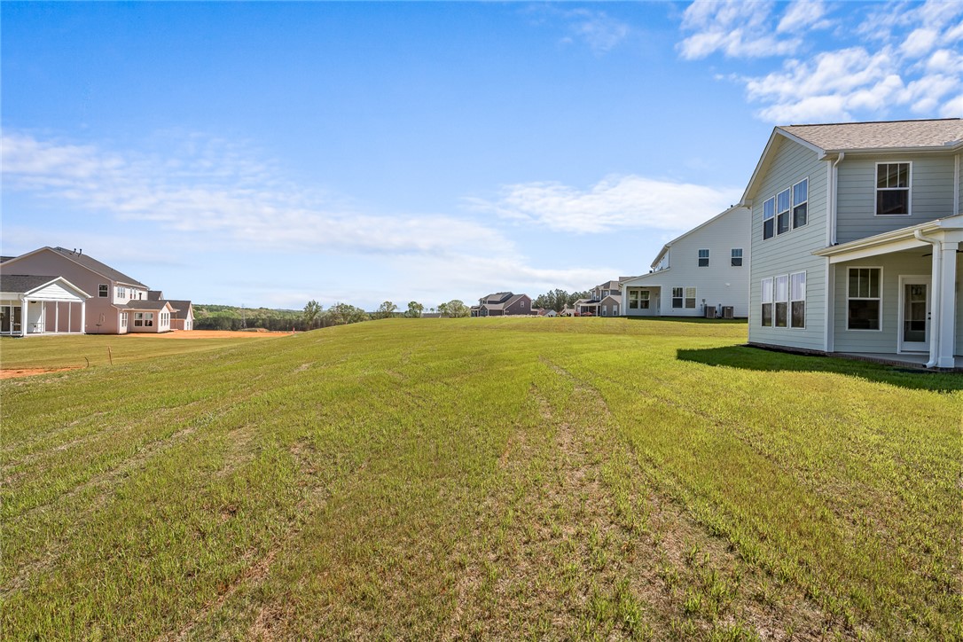 134 Ridgeline Row Central, SC 29630 - Photo 44 of 47 Expansive green yard with distant homes, offering clear skies.