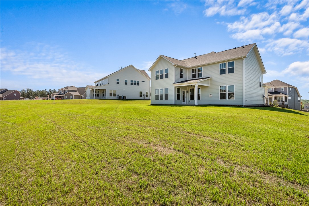 134 Ridgeline Row Central, SC 29630 - Photo 45 of 47 This spacious backyard offers ample green space and a covered patio, perfect for outdoor enjoyment.