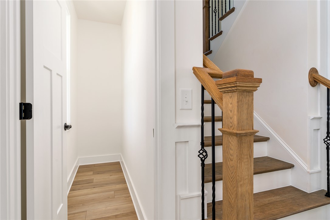 134 Ridgeline Row Central, SC 29630 - Photo 7 of 47 This entry area features wood flooring and a classic wooden staircase with wrought iron accents.