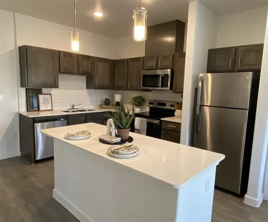 a kitchen with a sink a stove a refrigerator and cabinets