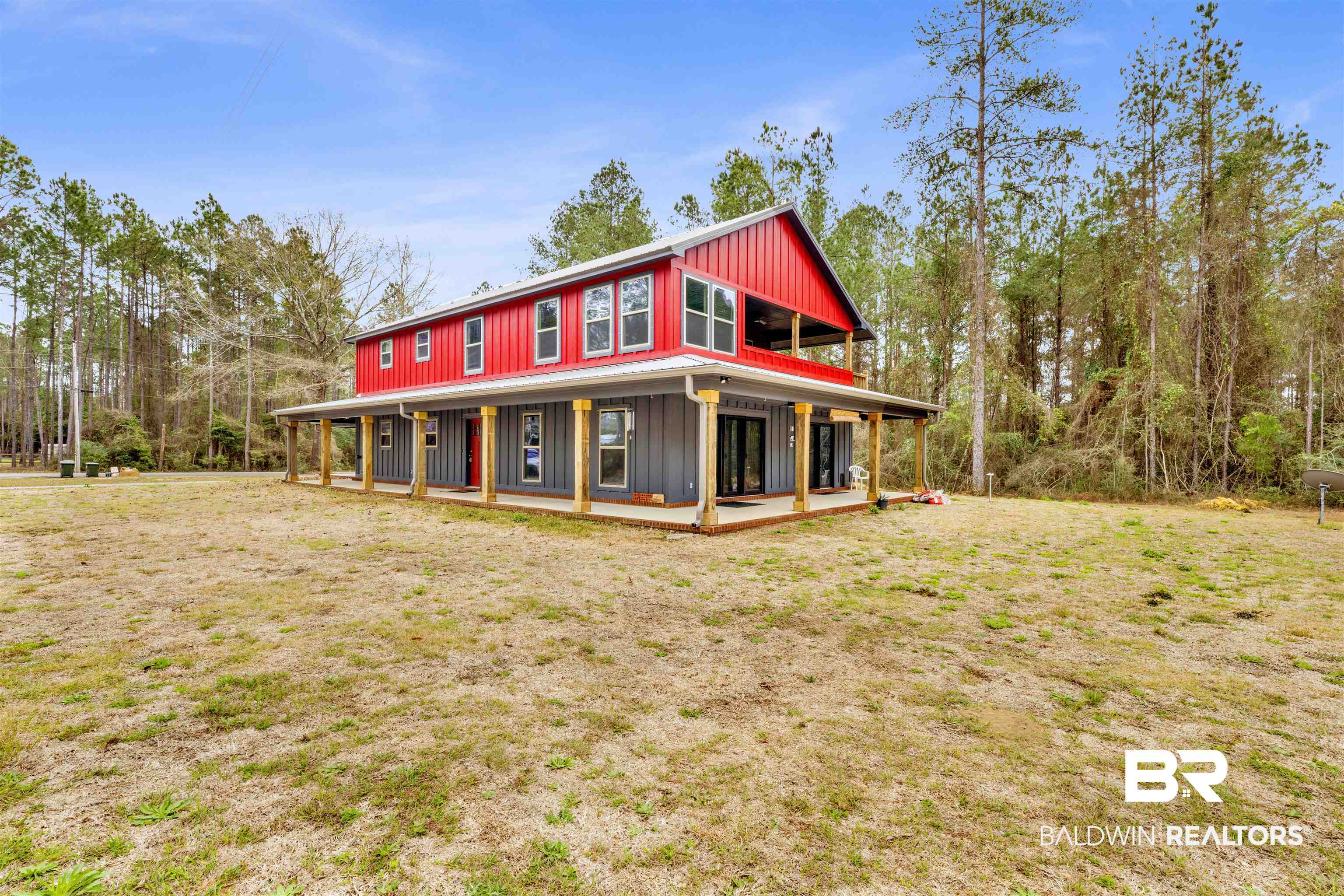 36397 Alexandria Trail Stapleton, AL 36578 - Photo 21 of 65 View of front of property featuring covered porch, a front yard, and board and batten siding