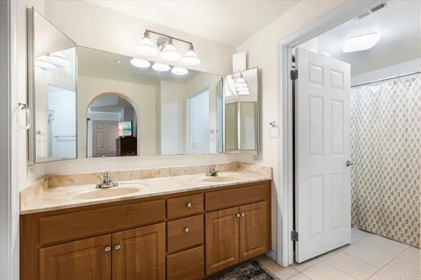 a bathroom with a granite countertop sink mirror and double