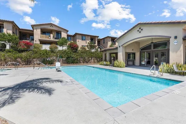 a front view of a house with swimming pool and porch