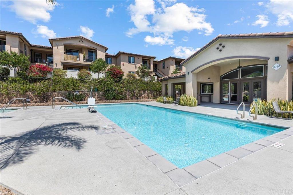 2715 Lake Pointe Drive, Unit 116 Spring Valley, CA 91977 - Photo 23 of 23 a front view of a house with swimming pool and porch