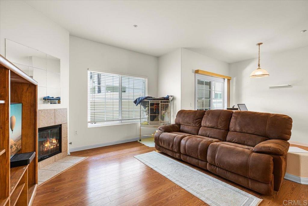 2715 Lake Pointe Drive, Unit 116 Spring Valley, CA 91977 - Photo 4 of 23 a living room with furniture window and a fireplace